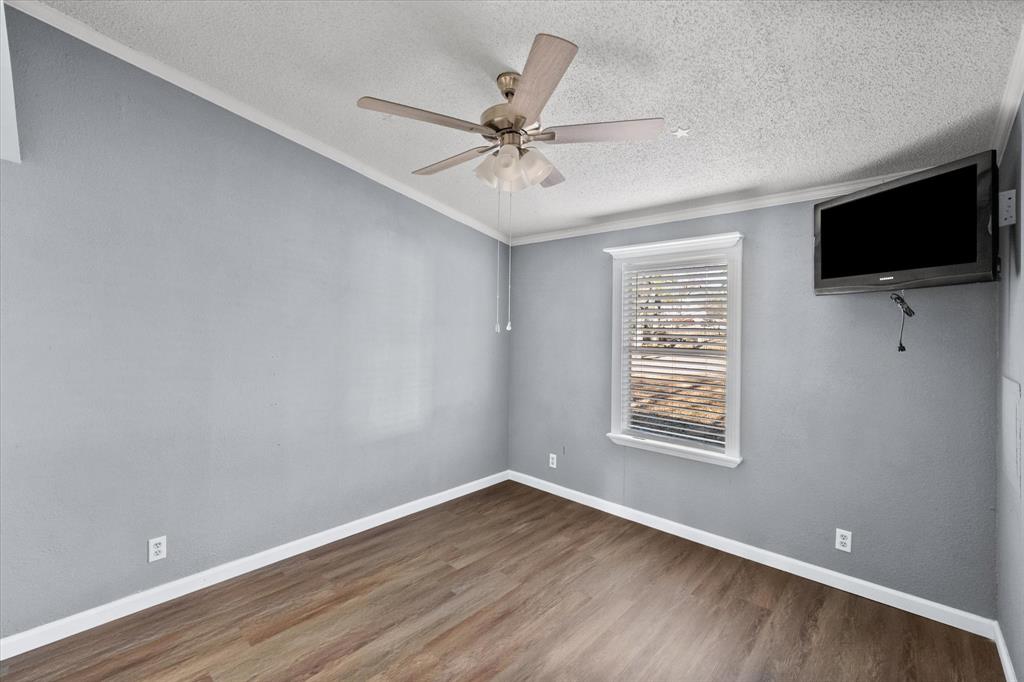 7634 Gibson Cemetery Road Mansfield, TX 76063 - Photo 8 of 11 wooden floor in an empty room with a window