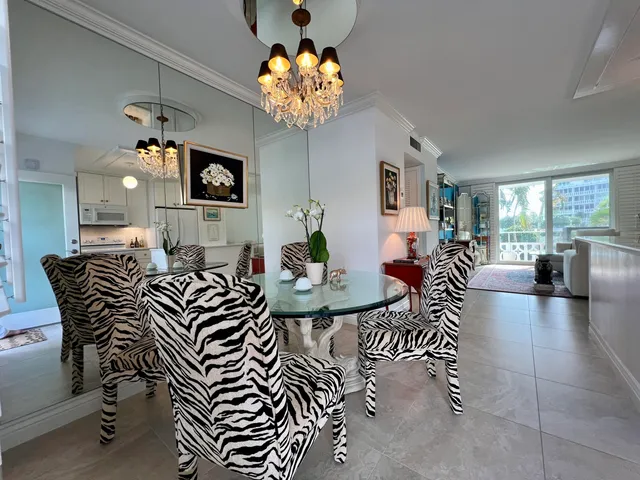 a kitchen with kitchen island a stove cabinets and living room view