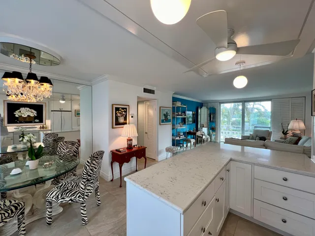 a kitchen with kitchen island granite countertop a sink cabinets and stainless steel appliances