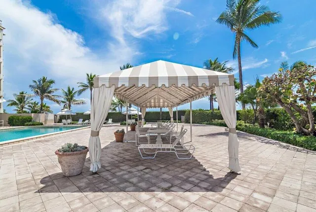 a view of a patio with a table and chairs