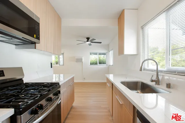 a kitchen with a sink and a stove top oven