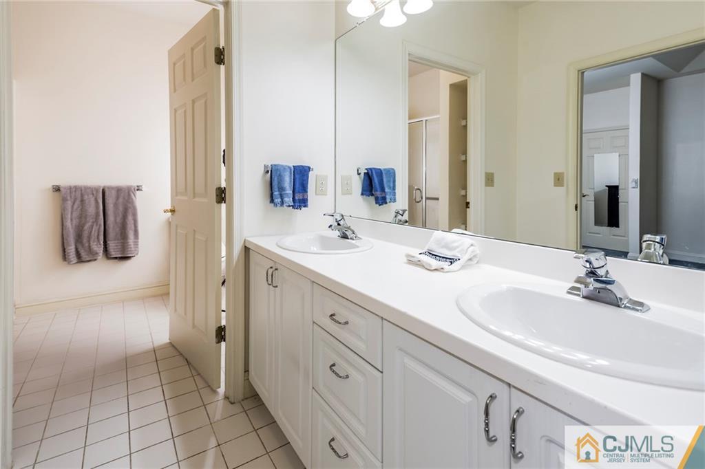 5 Hedge Row Road Plainsboro, NJ 08540 - Photo 12 of 25 a bathroom with a double vanity sink and mirror