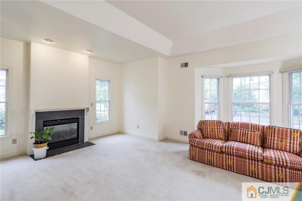 5 Hedge Row Road Plainsboro, NJ 08540 - Photo 4 of 25 a living room with furniture a flat screen tv and a fireplace