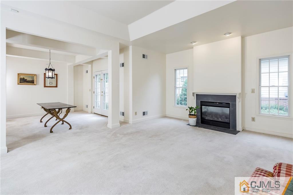 5 Hedge Row Road Plainsboro, NJ 08540 - Photo 5 of 25 a view of a livingroom with a chair and a fireplace
