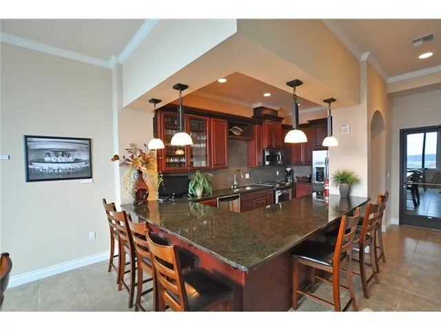 a view of dining room and livingroom with furniture a rug a flat screen tv and couches