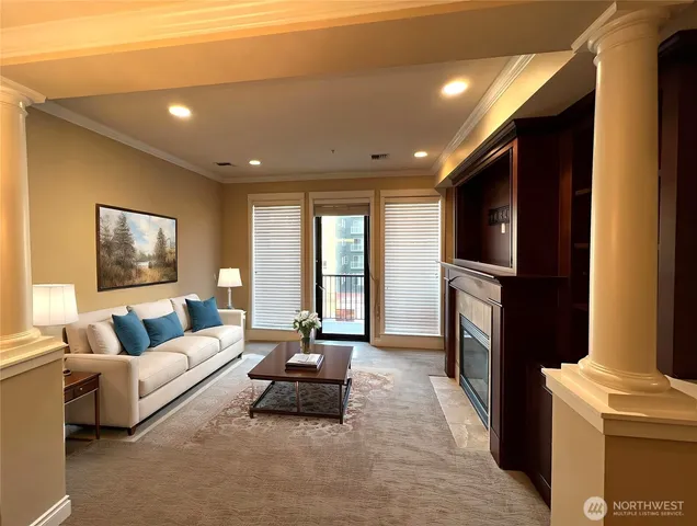 a living room with furniture a flat screen tv and a fireplace