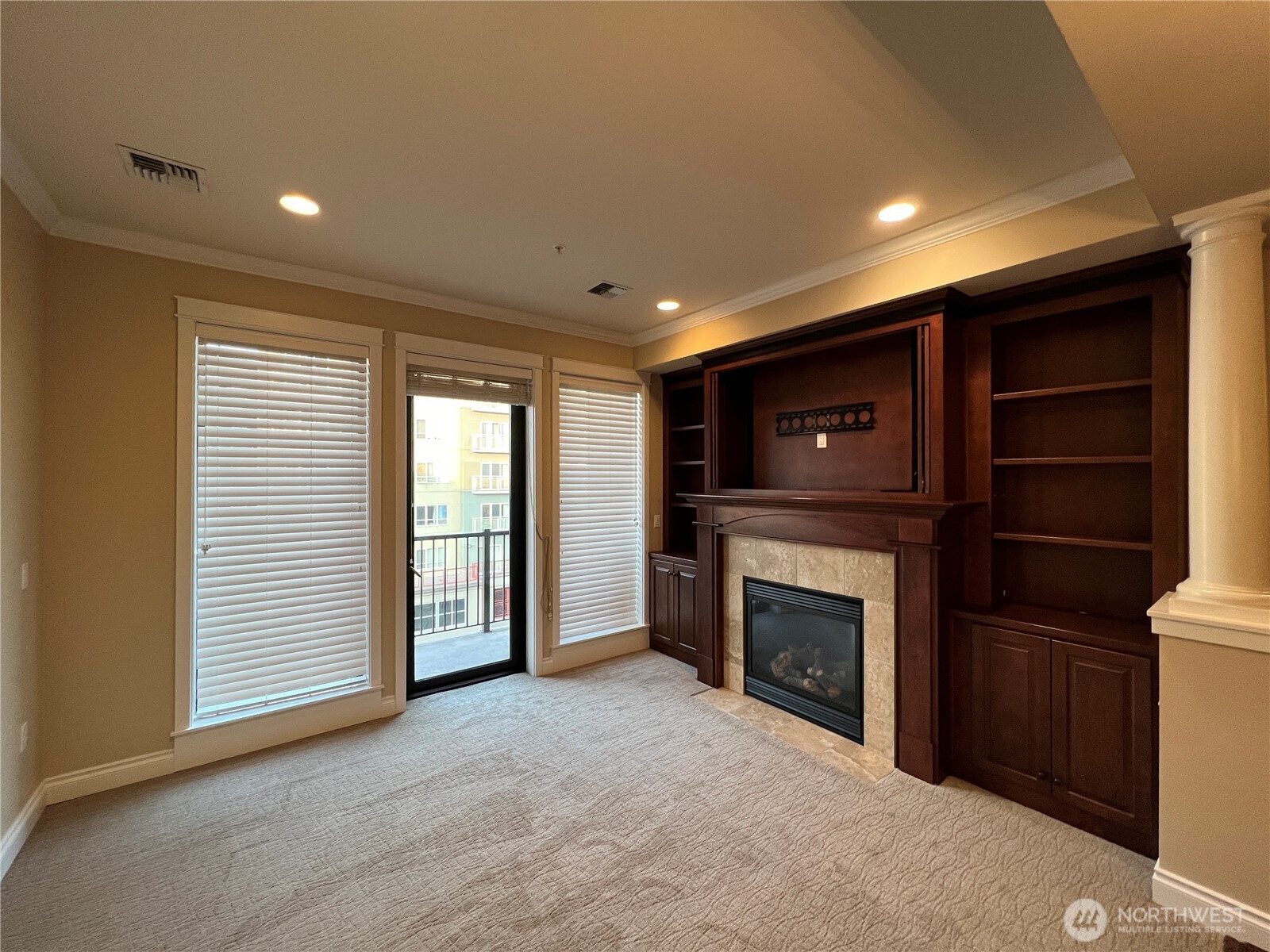 505 Broadway, Unit 802 Tacoma, WA 98402 - Photo 9 of 23 a view of an empty room with a fireplace and a window