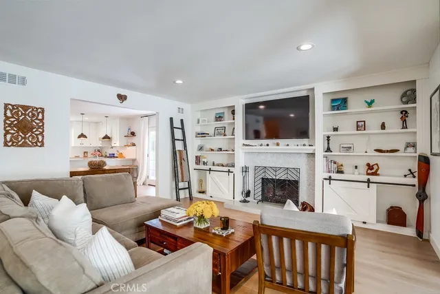 a dining room with furniture a chandelier and wooden floor