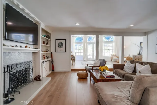 a living room with furniture a rug and a window