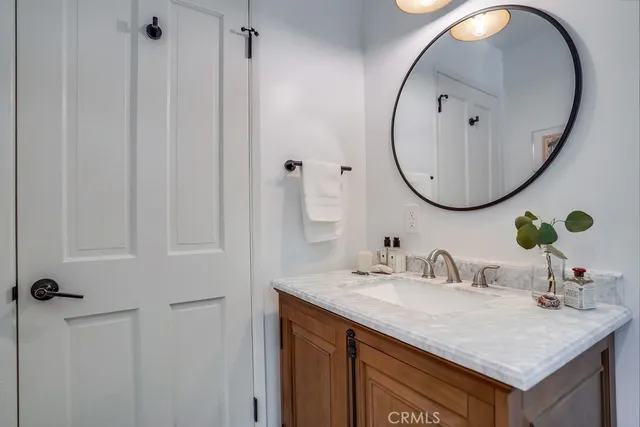a spacious bedroom with a bed and a chandelier