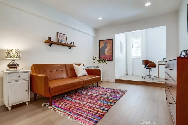 a bedroom with a large bed and a flat screen tv