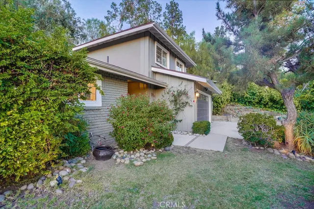 a kitchen with stainless steel appliances granite countertop white cabinets sink and a window