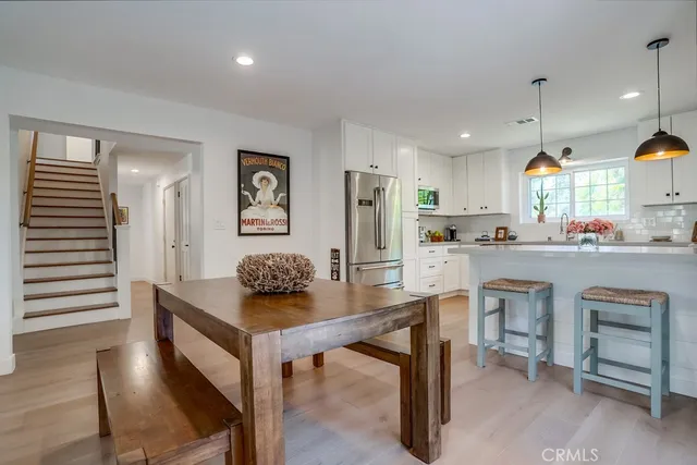 a living room with furniture and kitchen view