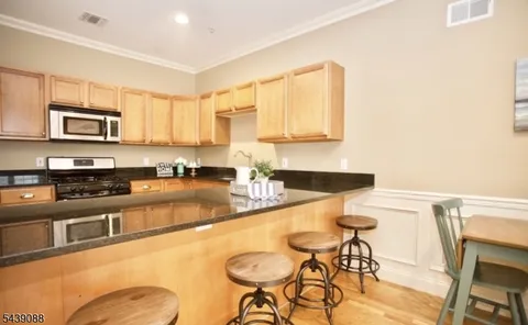 a kitchen with stainless steel appliances granite countertop a sink and a stove