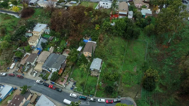 an aerial view of a house with a yard and lake view