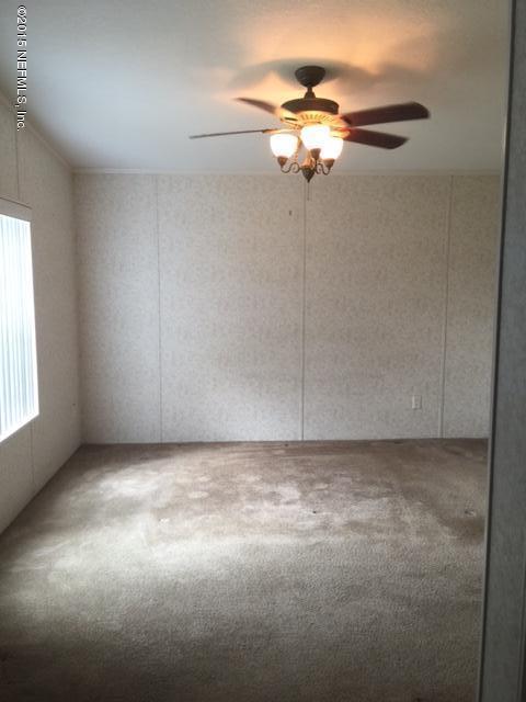 217 Barco Road St. Augustine, FL 32080 - Photo 11 of 18 a view of a livingroom with a ceiling fan and window