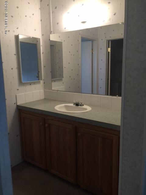 217 Barco Road St. Augustine, FL 32080 - Photo 12 of 18 a bathroom with a sink and a mirror