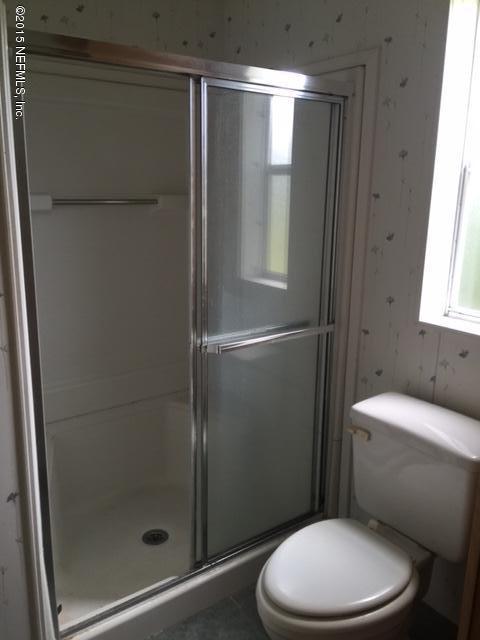 217 Barco Road St. Augustine, FL 32080 - Photo 13 of 18 a white toilet sitting next to a bathroom sink