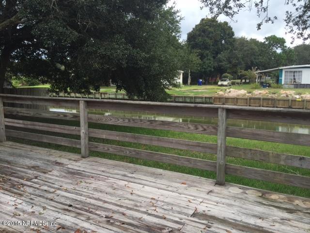 217 Barco Road St. Augustine, FL 32080 - Photo 15 of 18 a view of backyard with wooden deck and lake view
