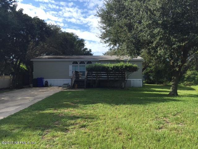 217 Barco Road St. Augustine, FL 32080 - Photo 3 of 18 a front view of a house with a garden