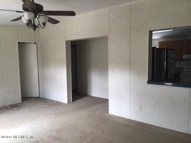 217 Barco Road St. Augustine, FL 32080 - Photo 5 of 18 an empty room with closet and a chandelier fan