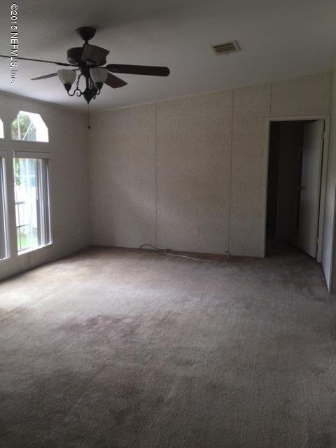 217 Barco Road St. Augustine, FL 32080 - Photo 10 of 18 a view of a livingroom with a ceiling fan and window