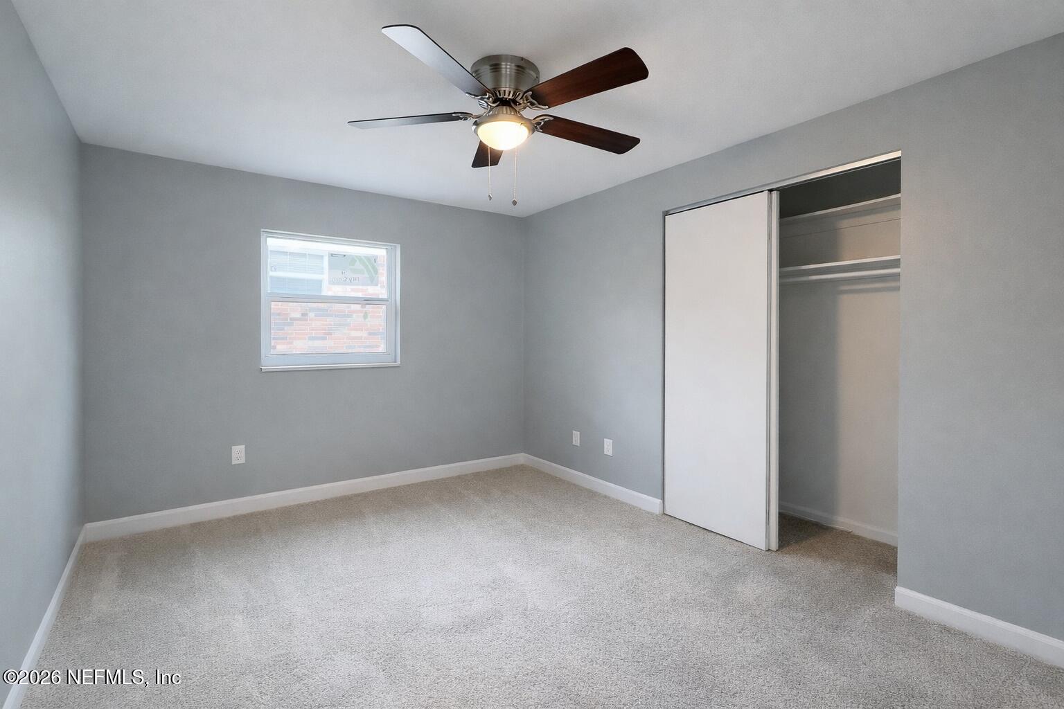 814 Greeland Avenue Jacksonville, FL 32221 - Photo 12 of 17 an empty room with ceiling fan and windows