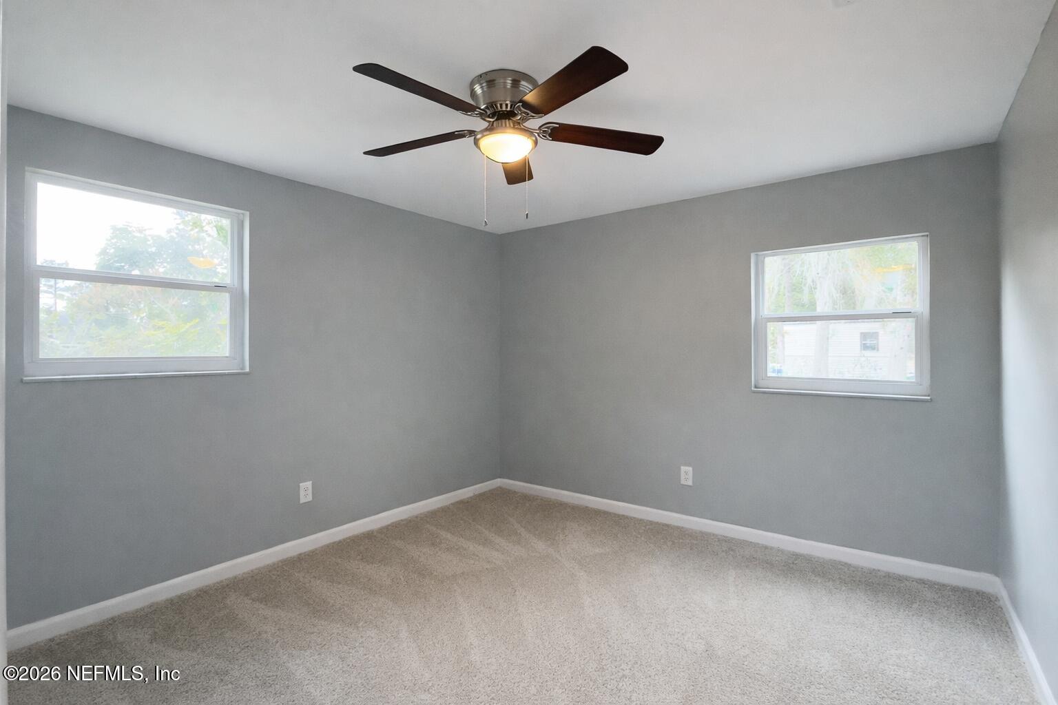 814 Greeland Avenue Jacksonville, FL 32221 - Photo 14 of 17 an empty room with a window and a ceiling fan