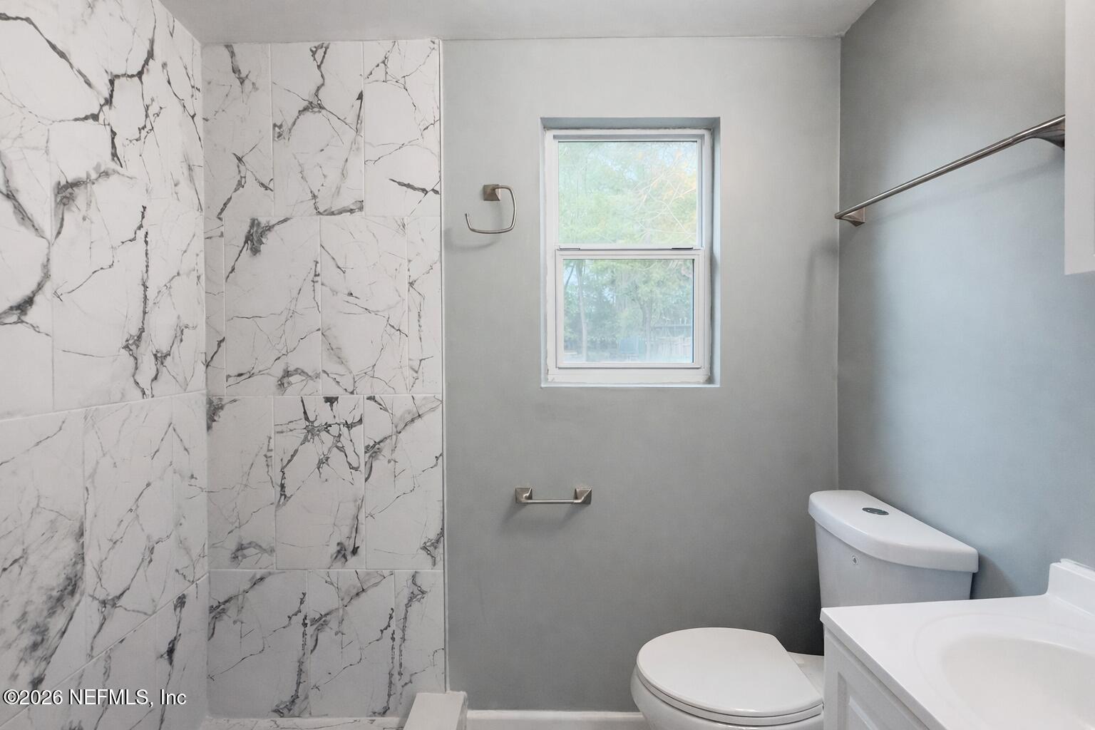 814 Greeland Avenue Jacksonville, FL 32221 - Photo 15 of 17 a white toilet sitting next to a shower curtain