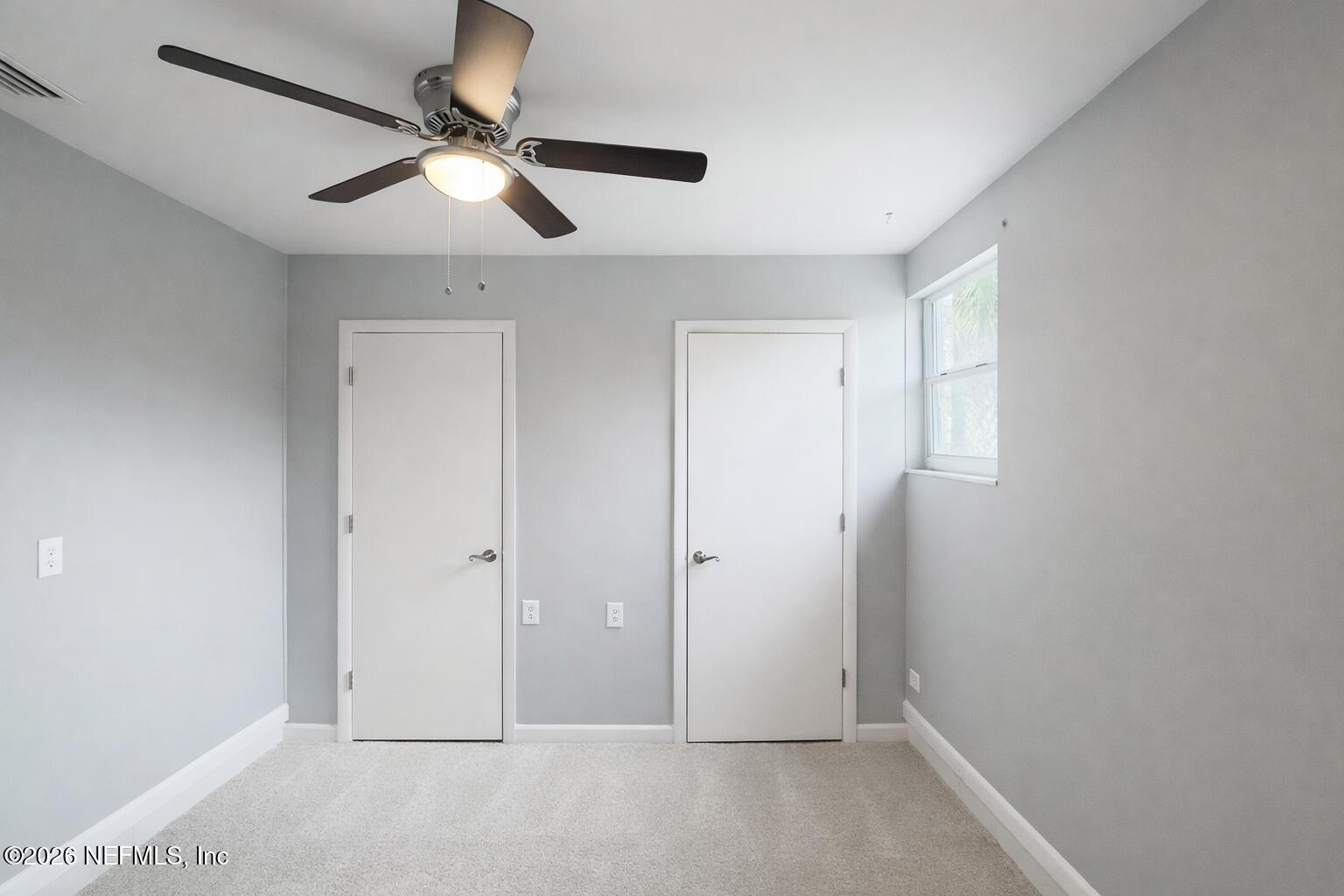 814 Greeland Avenue Jacksonville, FL 32221 - Photo 16 of 17 an empty room with ceiling fan and window