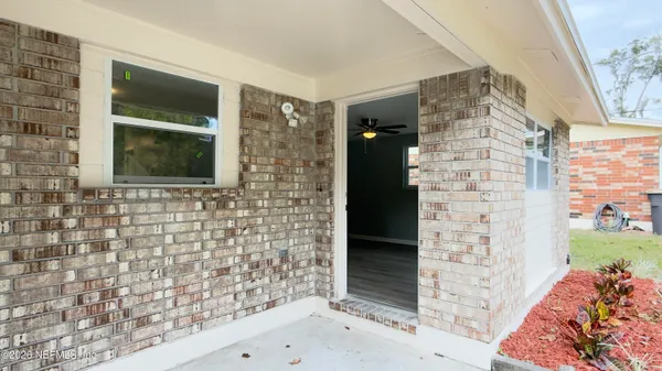 a brick building with a door and a window