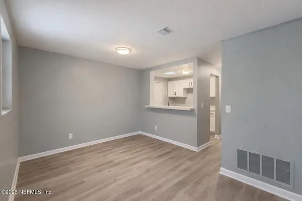 a view of a room with wooden floor and windows