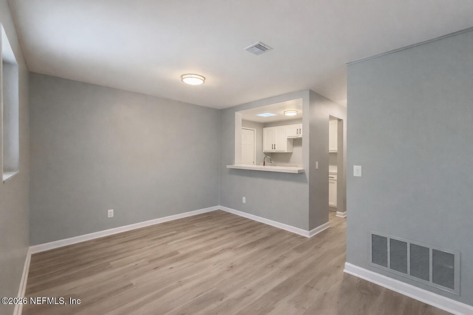 814 Greeland Avenue Jacksonville, FL 32221 - Photo 7 of 17 a view of a room with wooden floor and windows