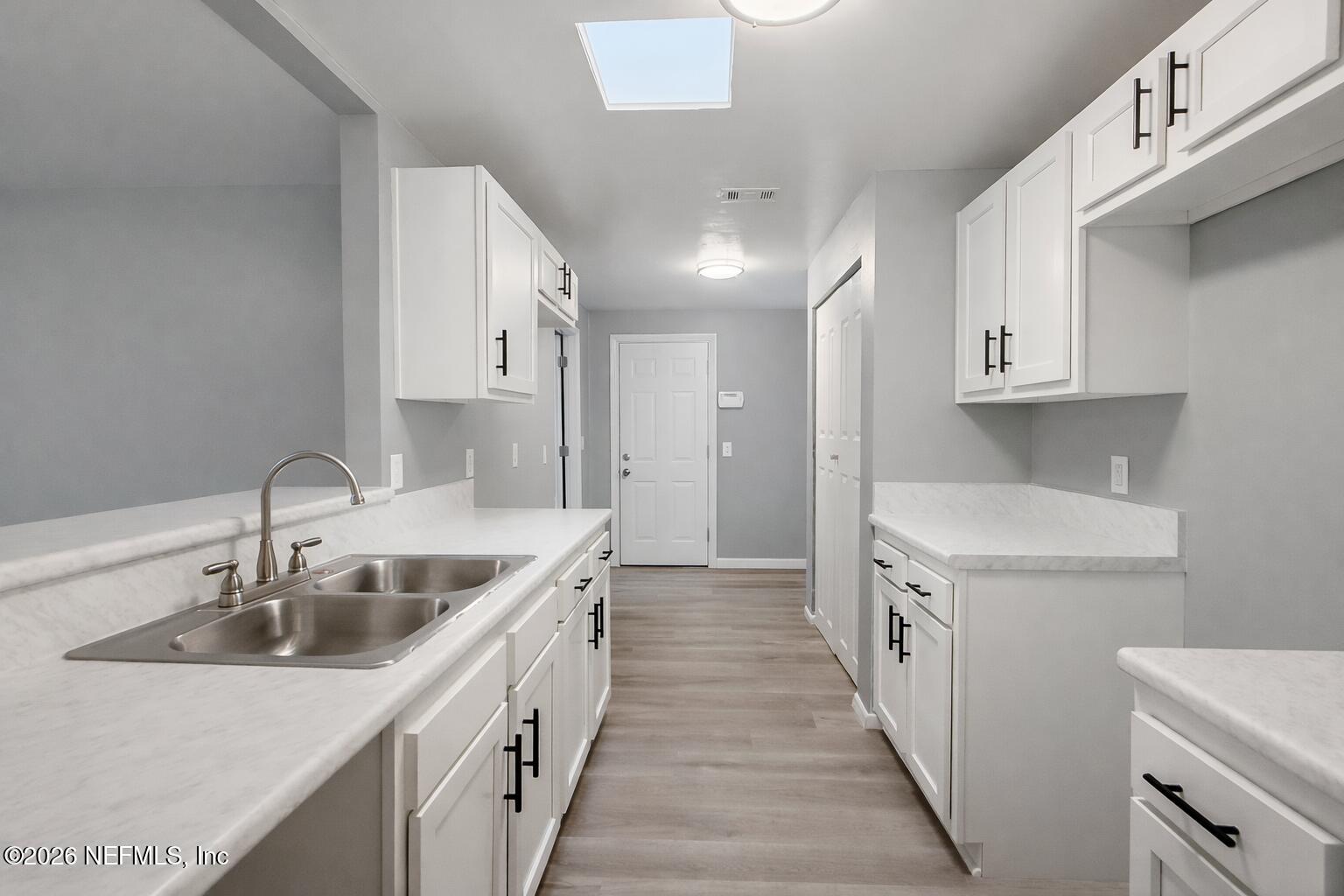 814 Greeland Avenue Jacksonville, FL 32221 - Photo 9 of 17 a kitchen with a sink stove top oven and cabinets