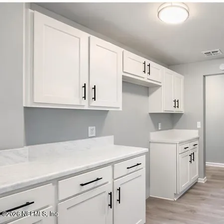 a kitchen with stainless steel appliances white cabinets and a sink