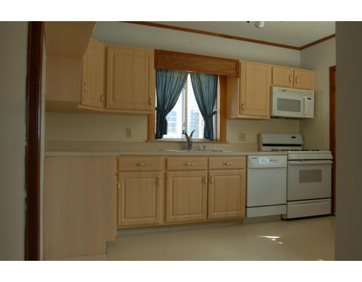 67 Overlook Road Arlington, MA 02474 - Photo 5 of 10 a kitchen with white cabinets and white appliances