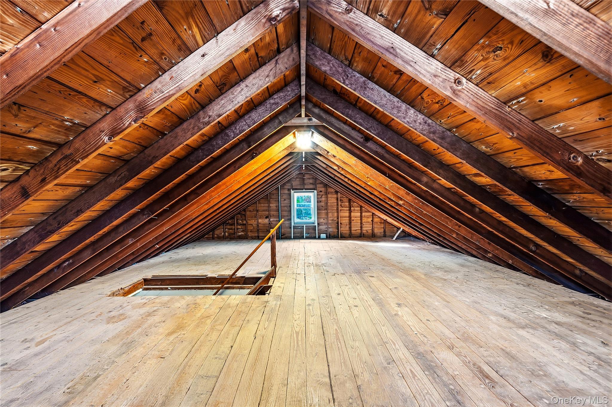 1550 Main Road Riverhead, NY 11901 - Photo 15 of 28 Spacious attic featuring exposed wood beams, wood-plank flooring, and sloped wood ceilings