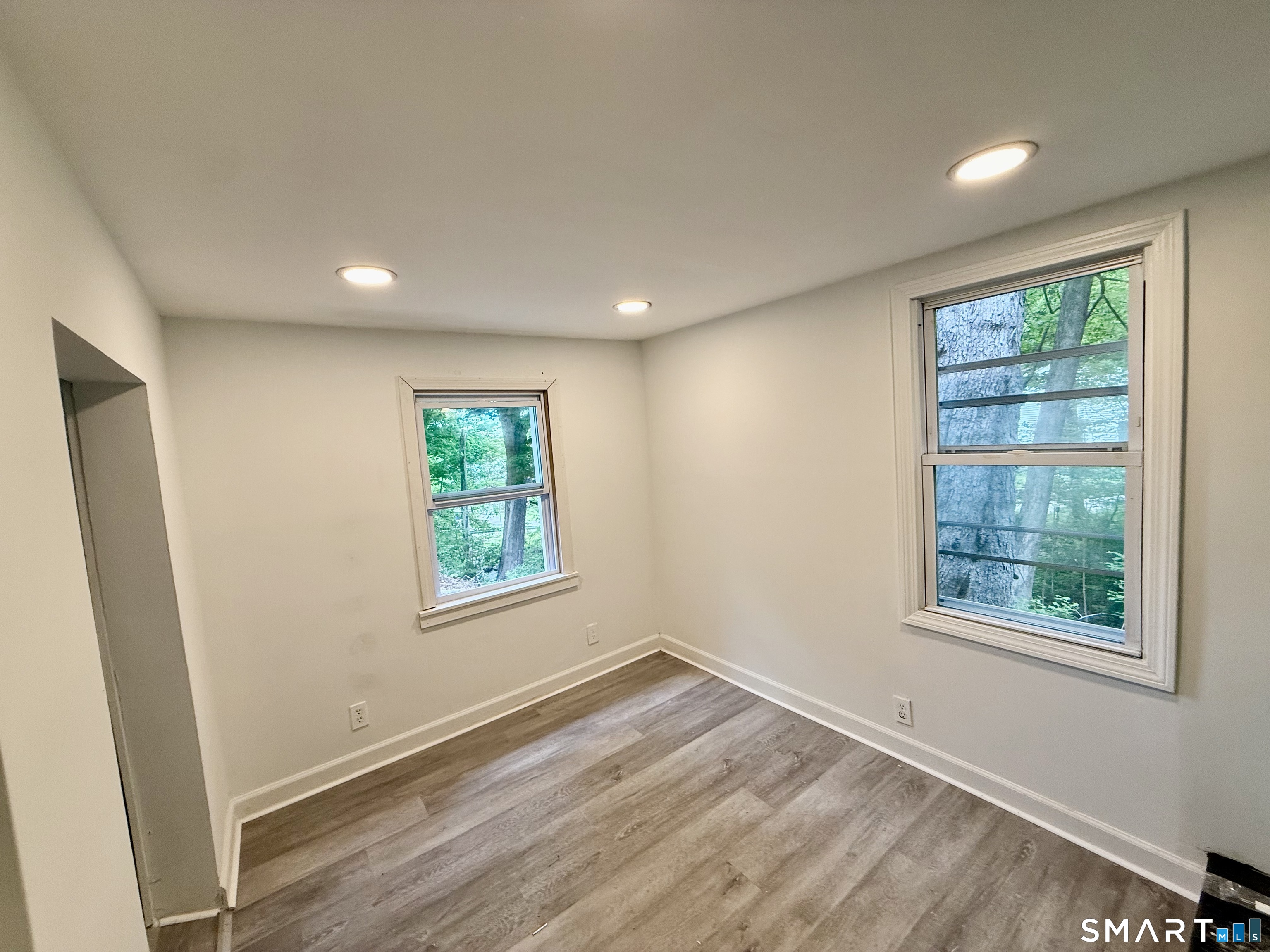 277 Lake Road Andover, CT 06232 - Photo 16 of 18 an empty room with wooden floor and windows