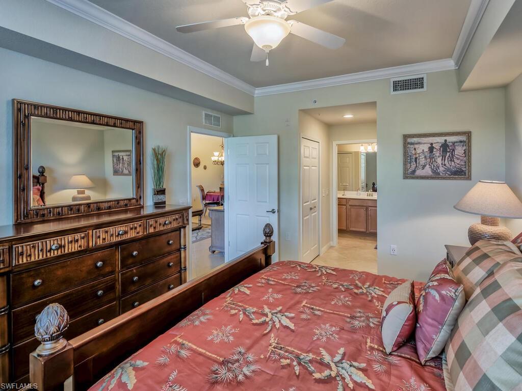 9735 Acqua Court, Unit 635 Naples, FL 34113 - Photo 11 of 33 a bedroom with a bed and a dresser in it