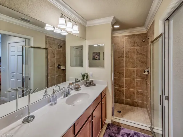 a bathroom with a shower sink and mirror