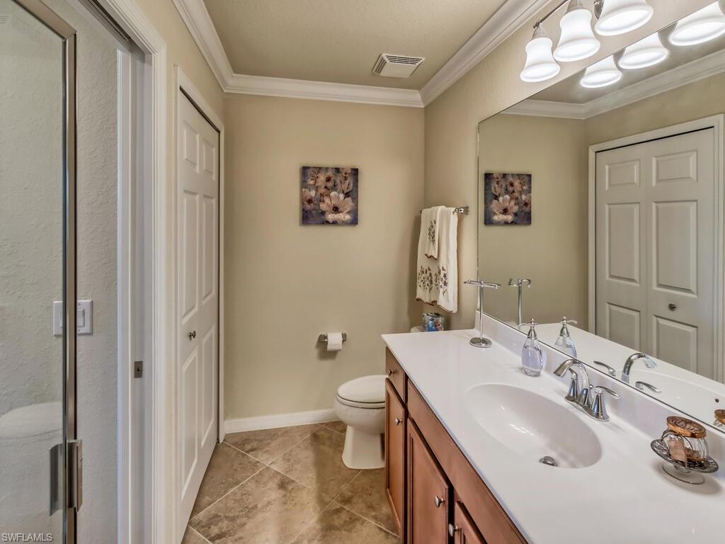 9735 Acqua Court, Unit 635 Naples, FL 34113 - Photo 13 of 33 a bathroom with a sink a toilet and shower