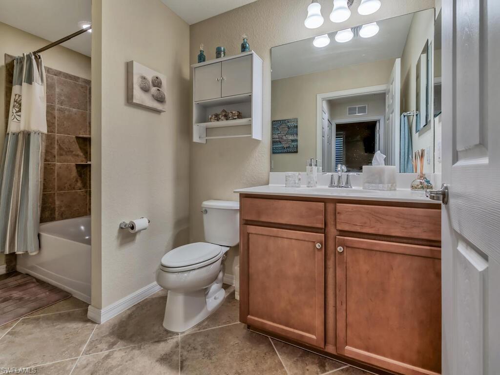 9735 Acqua Court, Unit 635 Naples, FL 34113 - Photo 16 of 33 a bathroom with a sink toilet and shower