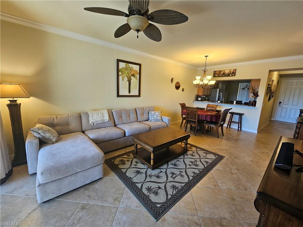 9735 Acqua Court, Unit 635 Naples, FL 34113 - Photo 2 of 33 a living room with furniture a ceiling fan and a rug