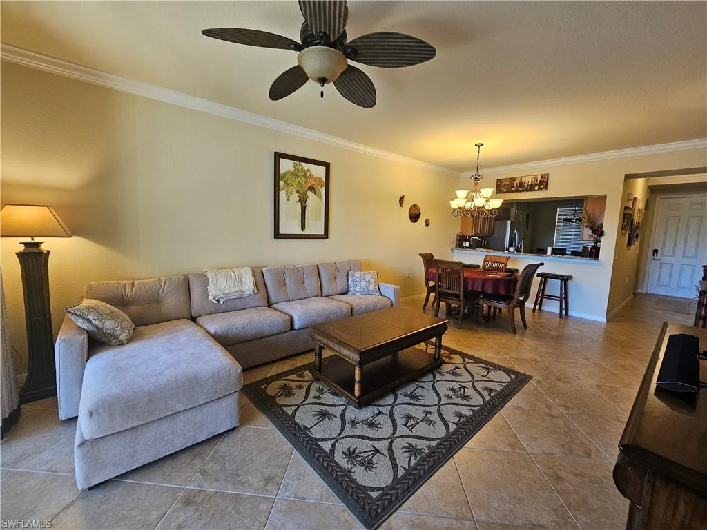 9735 Acqua Court, Unit 635 Naples, FL 34113 - Photo 6 of 33 a living room with furniture and a chandelier