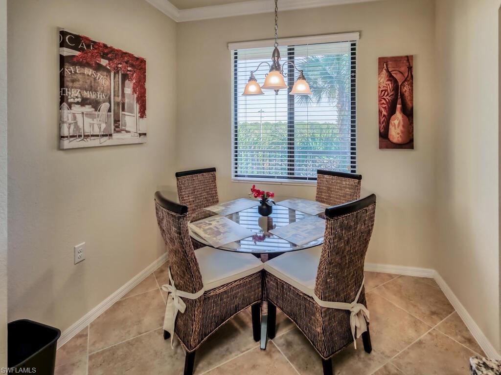 9735 Acqua Court, Unit 635 Naples, FL 34113 - Photo 10 of 33 a dining room with furniture and window