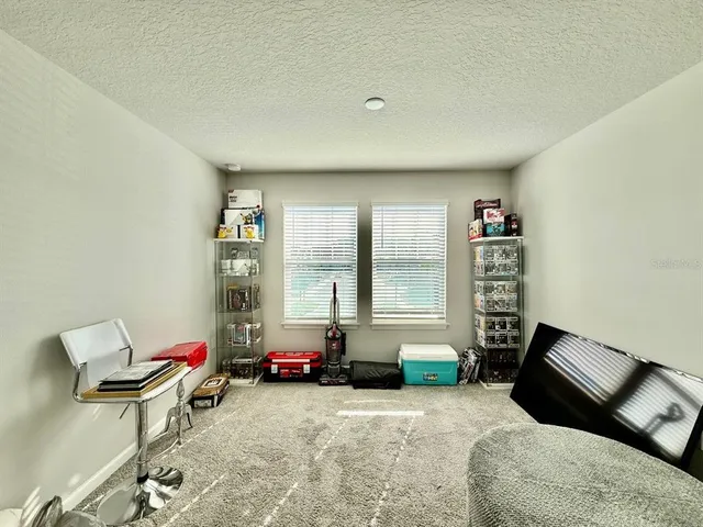 a bedroom with furniture and a window