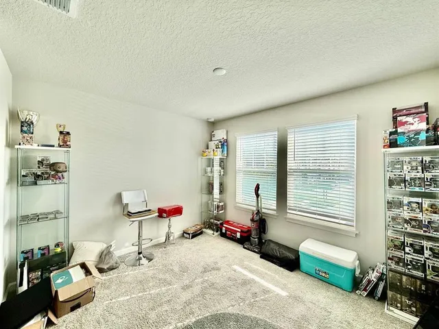 a bedroom with furniture and a window