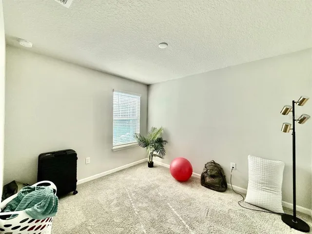 a bedroom with a bed and cabinets