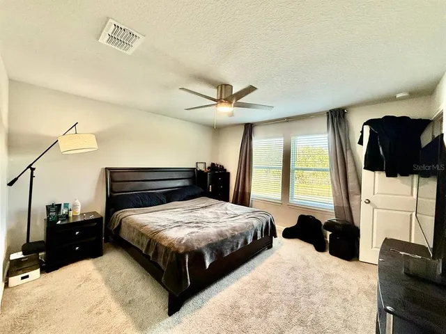 a bedroom with a bed and a couch