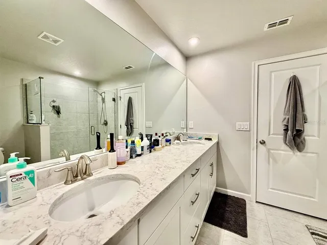 a bathroom with a granite countertop sink mirror and double